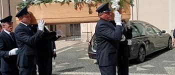Personale necroforo in divisa che trasporta feretro e auto funebre di Onoranze Funebri Musocco a Milano